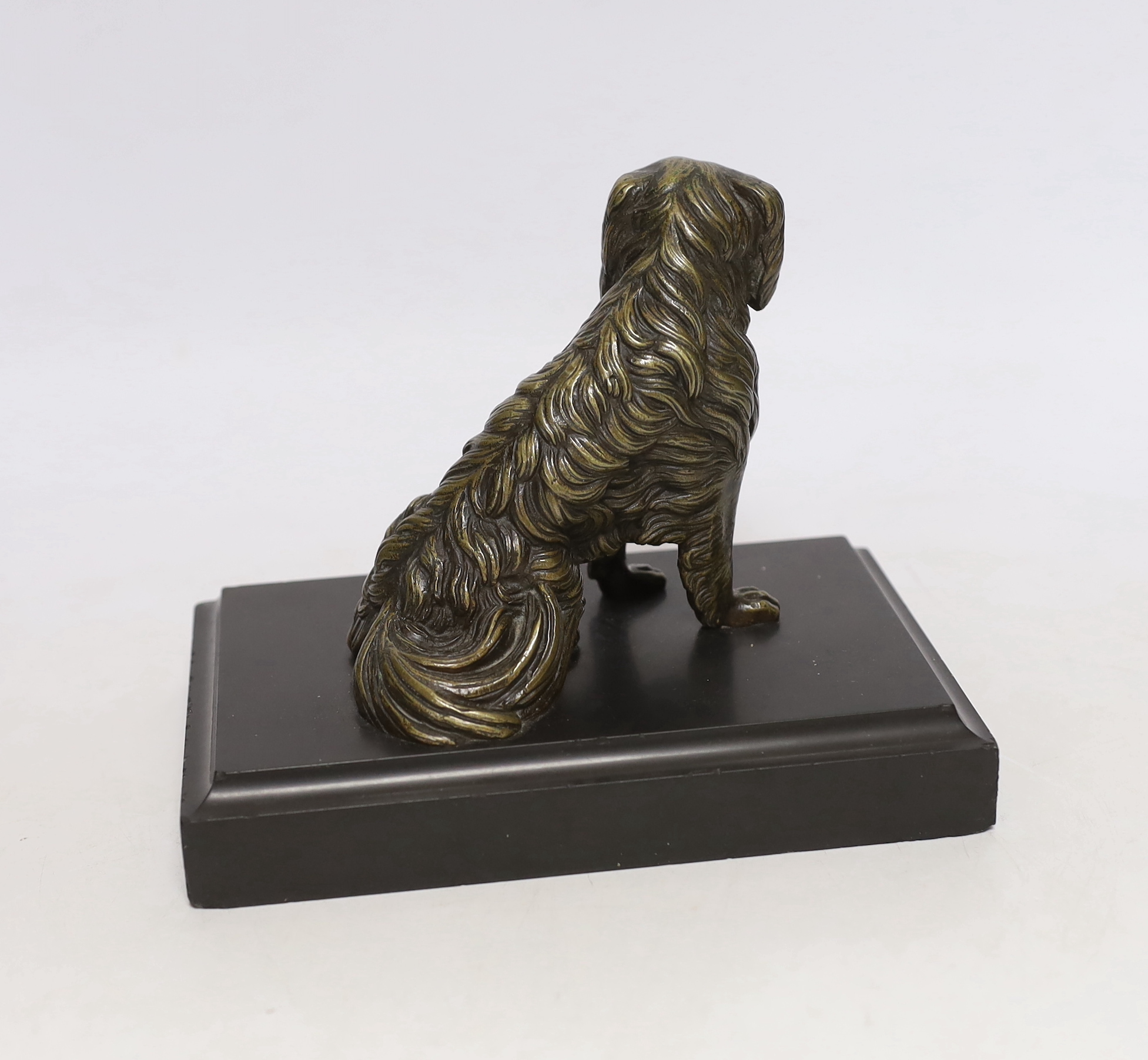A 19th century French bronze dog card holder with articulated jaw, raised on a slate base, 18cm wide
